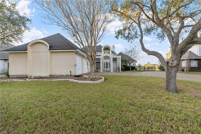 exterior space with a yard and a garage