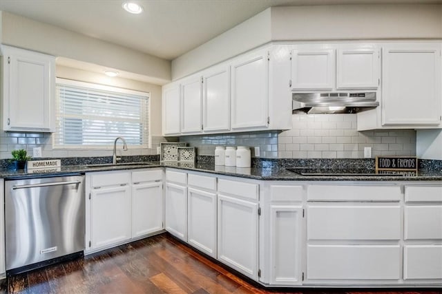 7421 Blue Lake Dr, Corpus Christi, TX 78413 - kitchen with stainless steel dishwasher, under cabinet range hood, black electric stovetop, white cabinets, and dark stone countertops