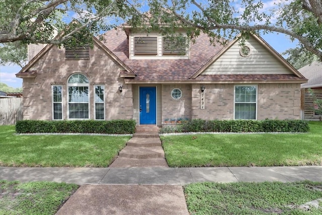 7421 Blue Lake Dr, Corpus Christi, TX 78413 - view of front of property with brick siding, a front yard, and a shingled roof