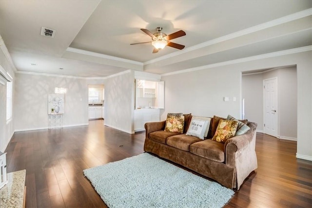 7421 Blue Lake Dr, Corpus Christi, TX 78413 - living area with dark wood-type flooring, ceiling fan, a tray ceiling, and crown molding