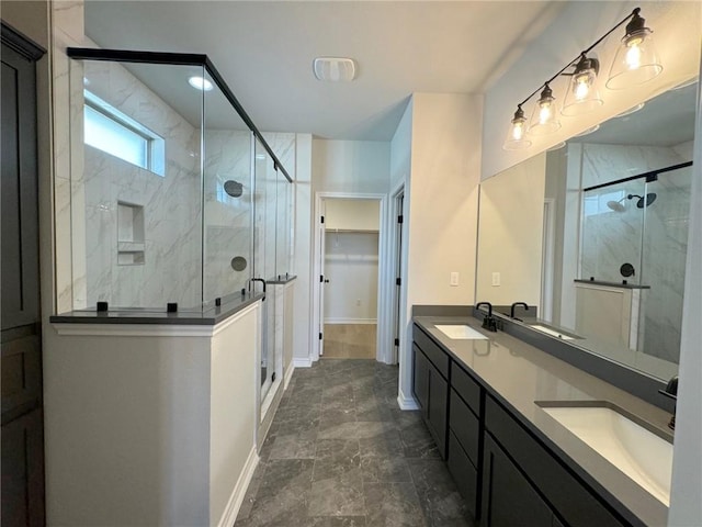 2605 Las Estrellas St, Corpus Christi, TX 78414 - bathroom with double vanity, a marble finish shower, baseboards, and a walk in closet