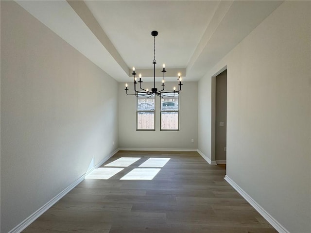 2605 Las Estrellas St, Corpus Christi, TX 78414 - unfurnished dining area featuring a chandelier, dark wood-style flooring, baseboards, and a raised ceiling