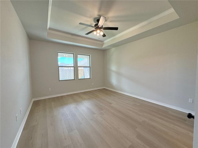 2605 Las Estrellas St, Corpus Christi, TX 78414 - empty room featuring a tray ceiling, ornamental molding, wood finished floors, a ceiling fan, and baseboards