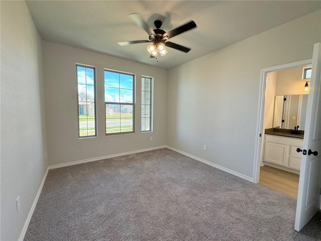 2605 Las Estrellas St, Corpus Christi, TX 78414 - spare room featuring light carpet, ceiling fan, baseboards, and a sink
