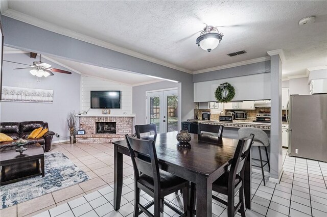 11805 Night Hawk, Corpus Christi, TX 78410 - dining room with light tile patterned flooring, a fireplace, ornamental molding, french doors, and ceiling fan