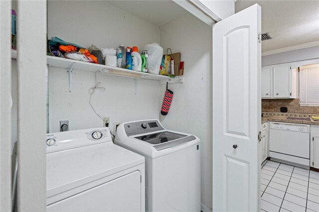 11805 Night Hawk, Corpus Christi, TX 78410 - laundry room with washer and dryer, light tile patterned flooring, and ornamental molding