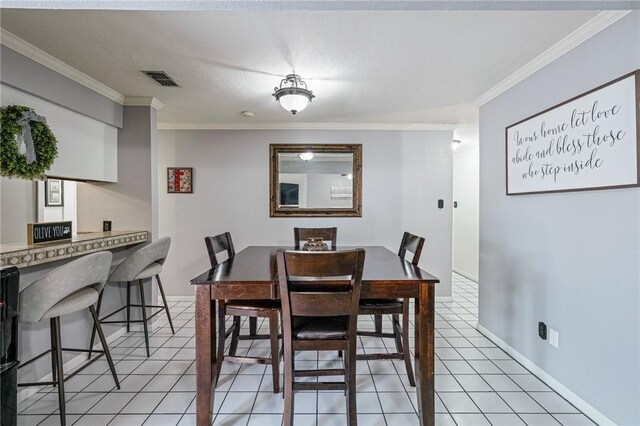 11805 Night Hawk, Corpus Christi, TX 78410 - dining space with crown molding, light tile patterned flooring, and baseboards