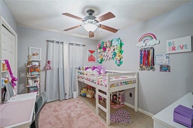 11805 Night Hawk, Corpus Christi, TX 78410 - bedroom featuring a ceiling fan, a textured ceiling, baseboards, and light tile patterned floors