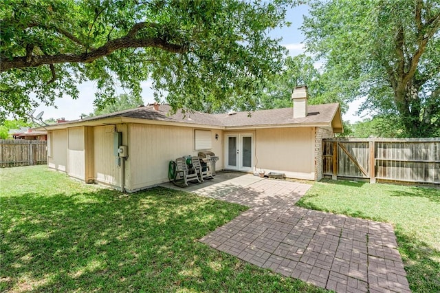 11805 Night Hawk, Corpus Christi, TX 78410 - rear view of house featuring french doors, a patio, and a chimney