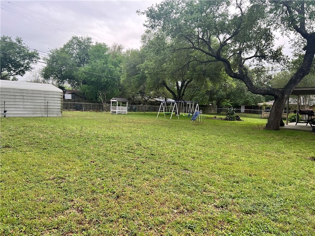 view of yard with a playground and a shed