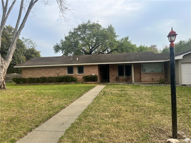 ranch-style home with a garage and a front yard