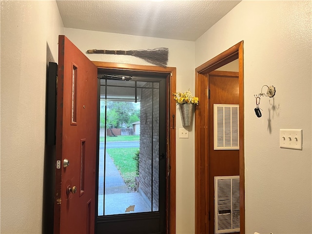 foyer entrance featuring a textured ceiling