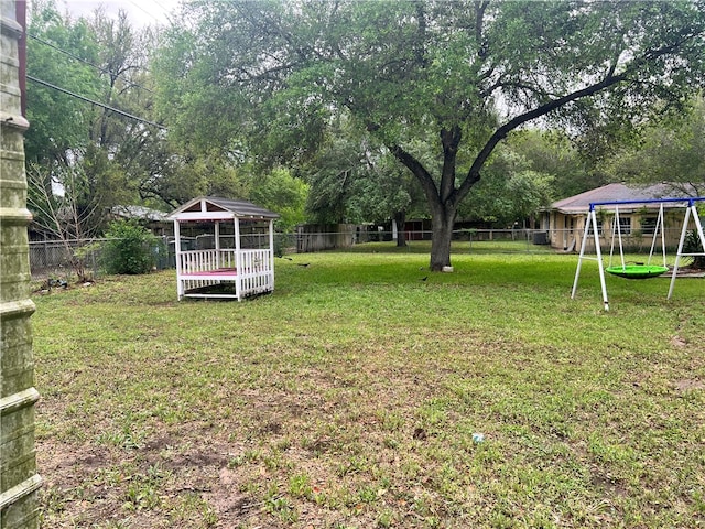 view of yard featuring a trampoline and a gazebo