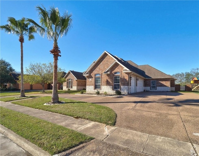 view of front of home featuring a garage and a front lawn