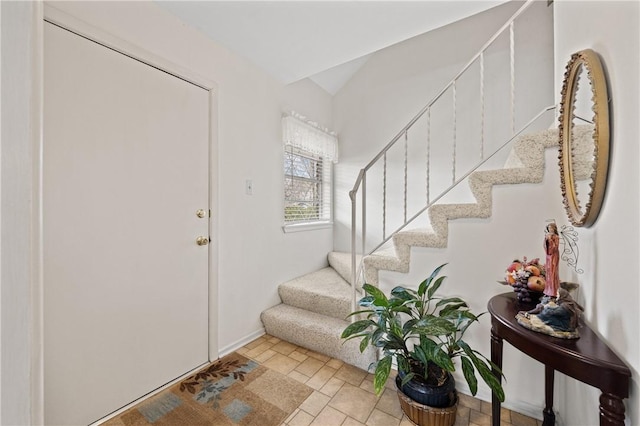 entryway with stone finish flooring and stairway