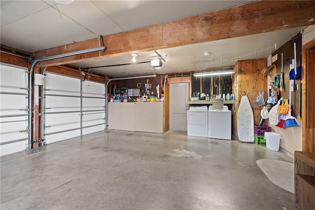 garage featuring separate washer and dryer and a garage door opener