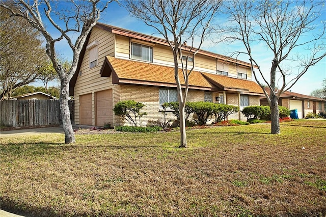 view of front of property featuring a front yard, fence, concrete driveway, and brick siding