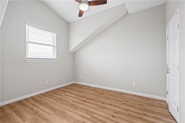 interior space featuring light wood-type flooring, baseboards, lofted ceiling, and ceiling fan