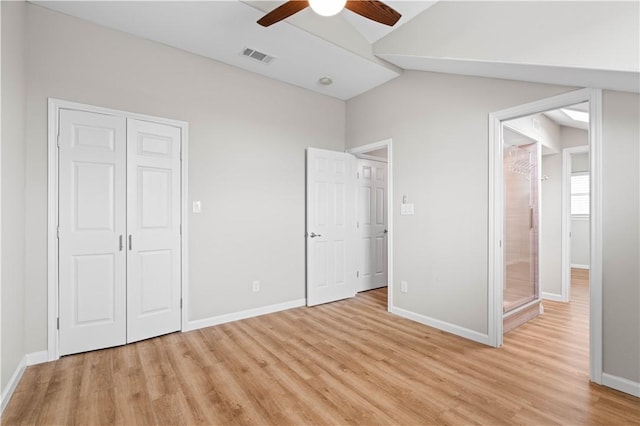 unfurnished bedroom with visible vents, baseboards, ceiling fan, light wood-style floors, and lofted ceiling