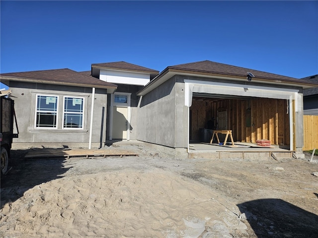 back of property featuring a garage