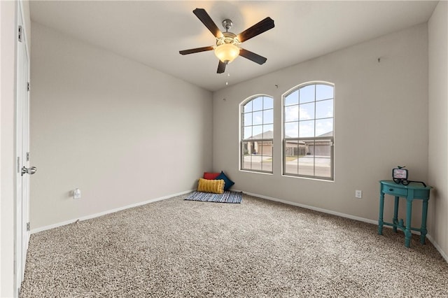 playroom with ceiling fan and carpet