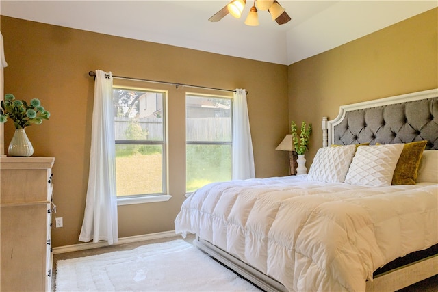 bedroom with vaulted ceiling, ceiling fan, and carpet floors