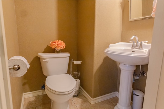 bathroom with tile patterned flooring and toilet