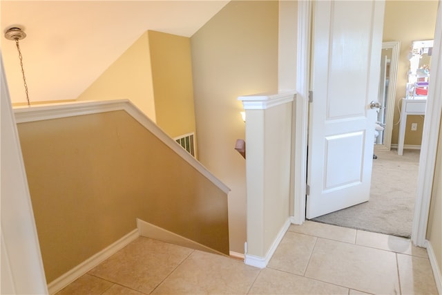 stairway featuring tile patterned flooring