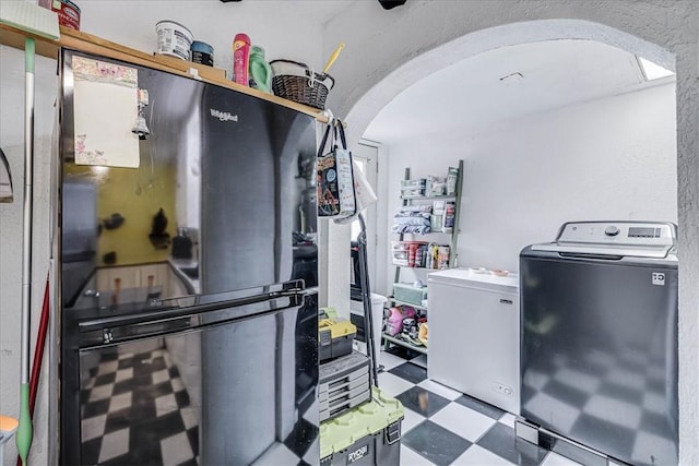 kitchen with washer / clothes dryer and fridge