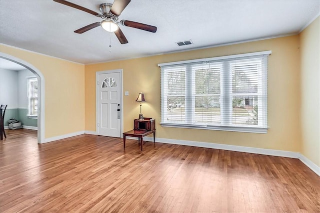 foyer entrance featuring ceiling fan and light wood-type flooring