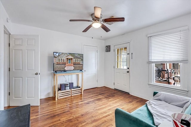 interior space with wood-type flooring and ceiling fan