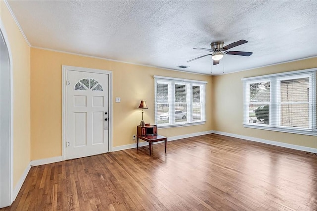 entryway featuring hardwood / wood-style floors, a textured ceiling, and ceiling fan