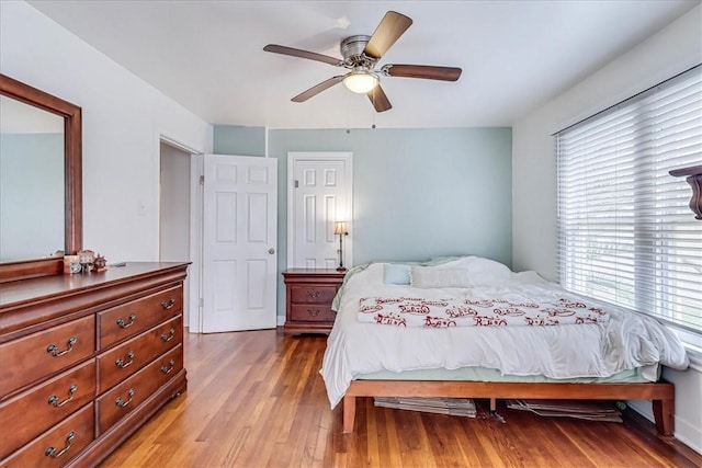 bedroom with ceiling fan and hardwood / wood-style flooring