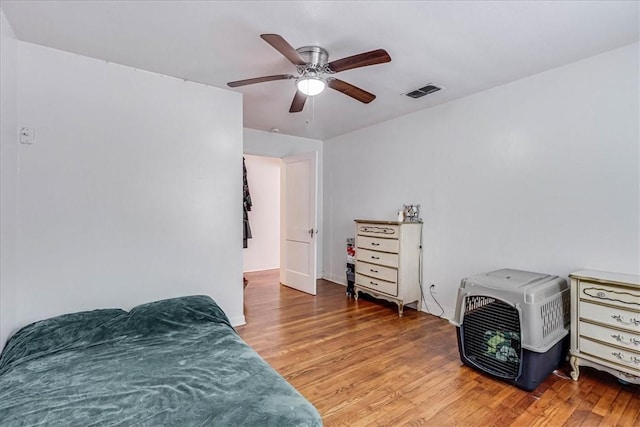 bedroom with hardwood / wood-style flooring and ceiling fan