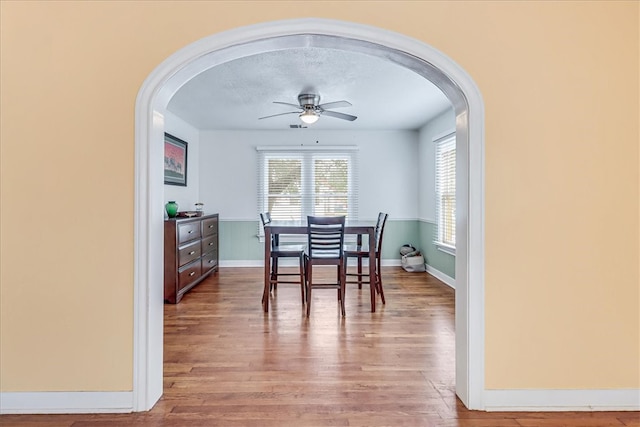 dining space with ceiling fan and hardwood / wood-style floors