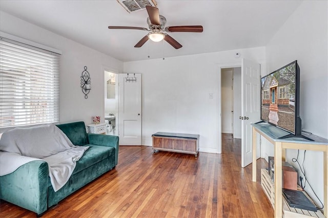 living room featuring wood-type flooring, plenty of natural light, and ceiling fan