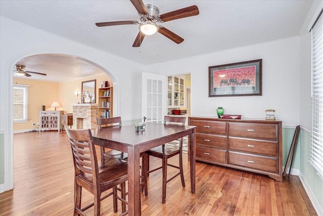 dining space with ceiling fan and wood-type flooring