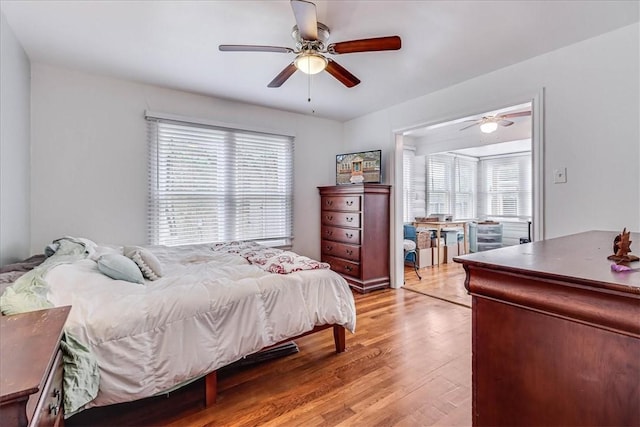 bedroom with ceiling fan and light hardwood / wood-style floors