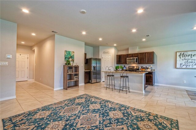 3922 Jayden Dr, Corpus Christi, TX 78410 - kitchen with appliances with stainless steel finishes, recessed lighting, light tile patterned flooring, a center island with sink, and dark brown cabinets