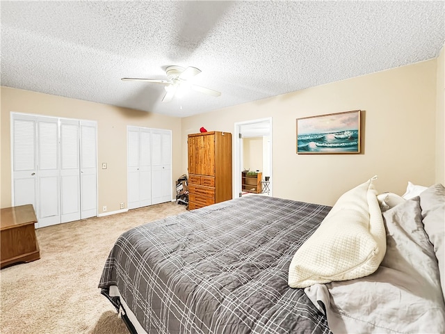 carpeted bedroom featuring ceiling fan and a textured ceiling