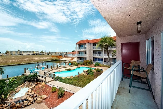 view of swimming pool with a water view