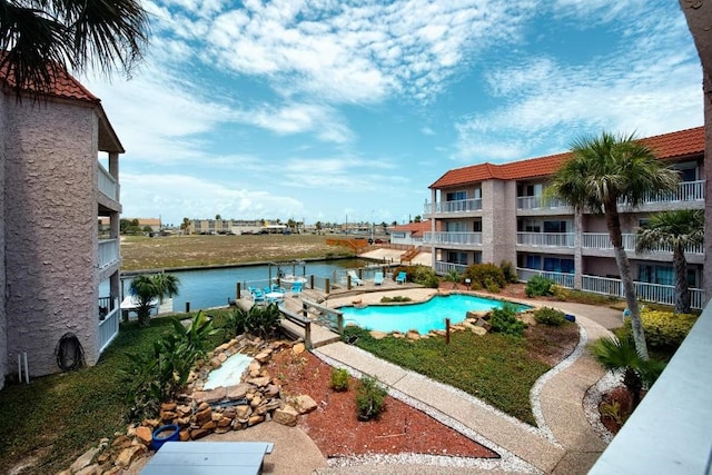 view of pool featuring a water view