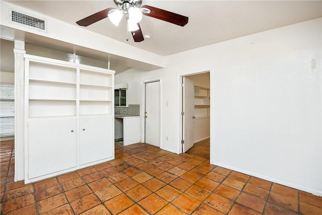 unfurnished bedroom featuring a closet, visible vents, ceiling fan, and baseboards