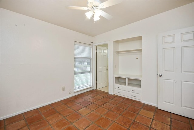 unfurnished bedroom with a ceiling fan, baseboards, and a closet
