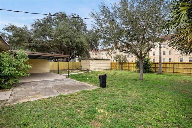 view of yard with an outbuilding, a storage shed, and a fenced backyard