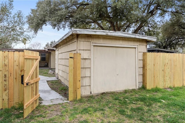 view of outbuilding with an outdoor structure and fence