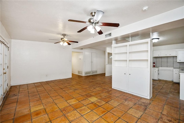 unfurnished living room with visible vents and a ceiling fan