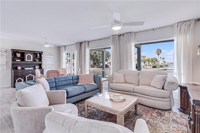 living room featuring light hardwood / wood-style floors and ceiling fan