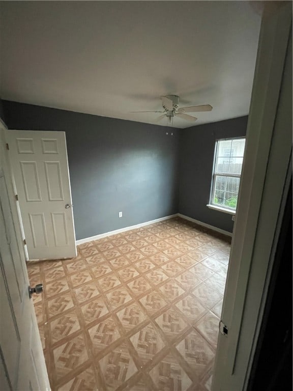 spare room with ceiling fan