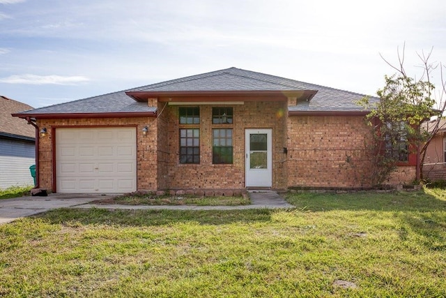 view of front of house with a garage and a front lawn